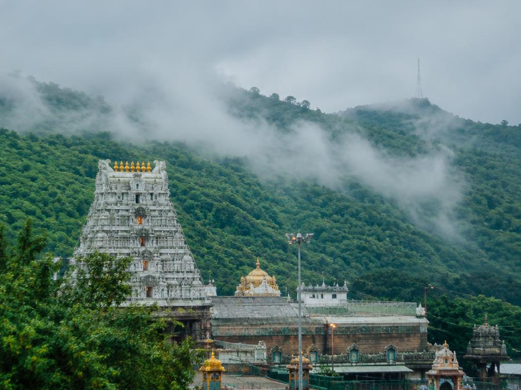 Temple tower below the misty Tirumala hills